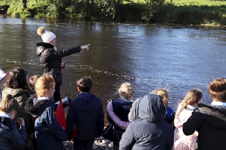 teaching pointing at river
